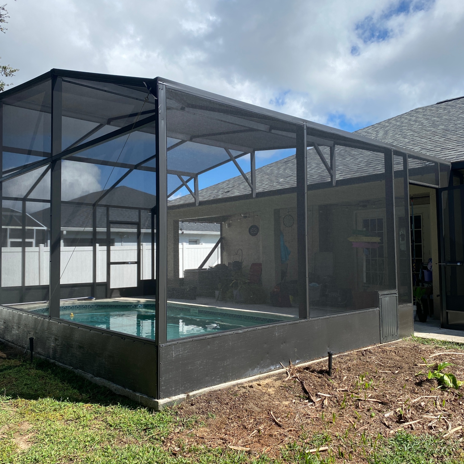 Luxury screen-enclosed pool at dusk